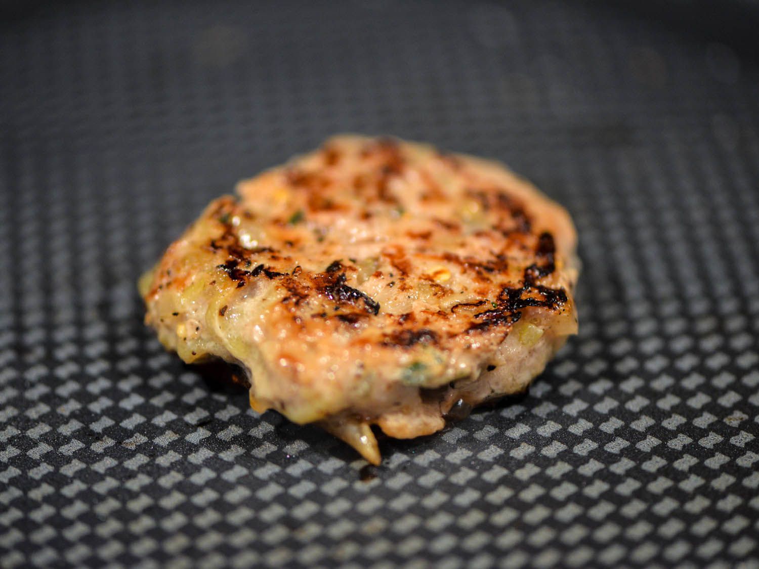 Cooking a turkey burger test patty.