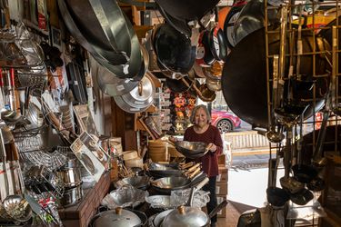 Tane Chan holding a wok in The Wok Shop