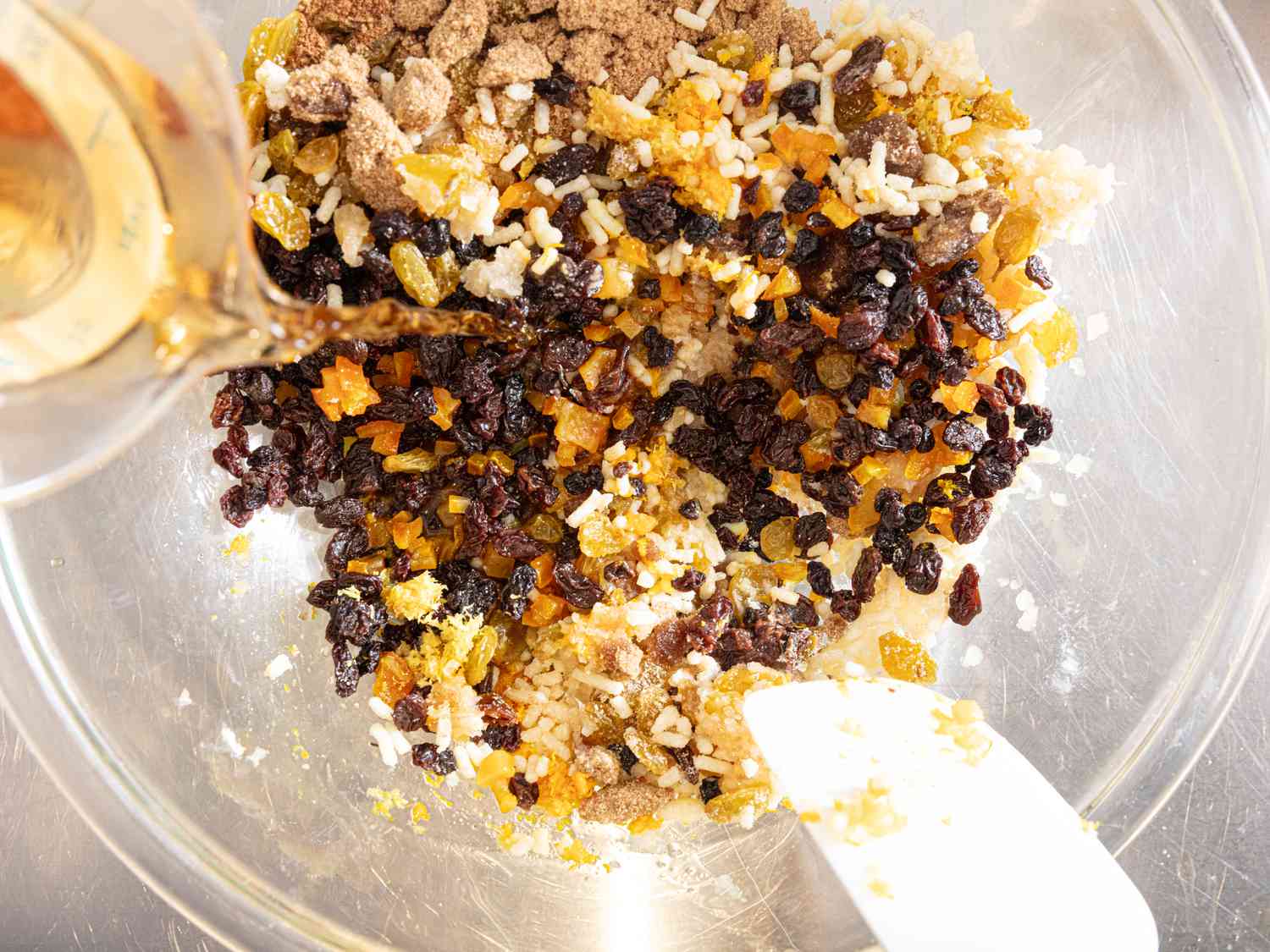 Adding Brandy to mixture and mixing with a spatula in a glass bowl 