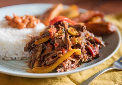 Cuban shredded beef plated with rice, beans. and plantains