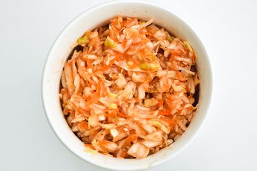 A cup of red Lexington-style coleslaw.