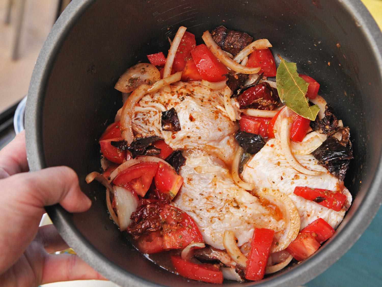Chicken thighs and sauce ingredients combined in a pressure cooker. 