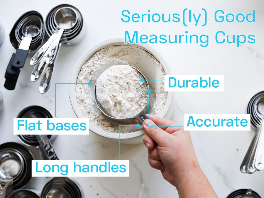 A person scooping out flour out of a canister with a measuring cup.