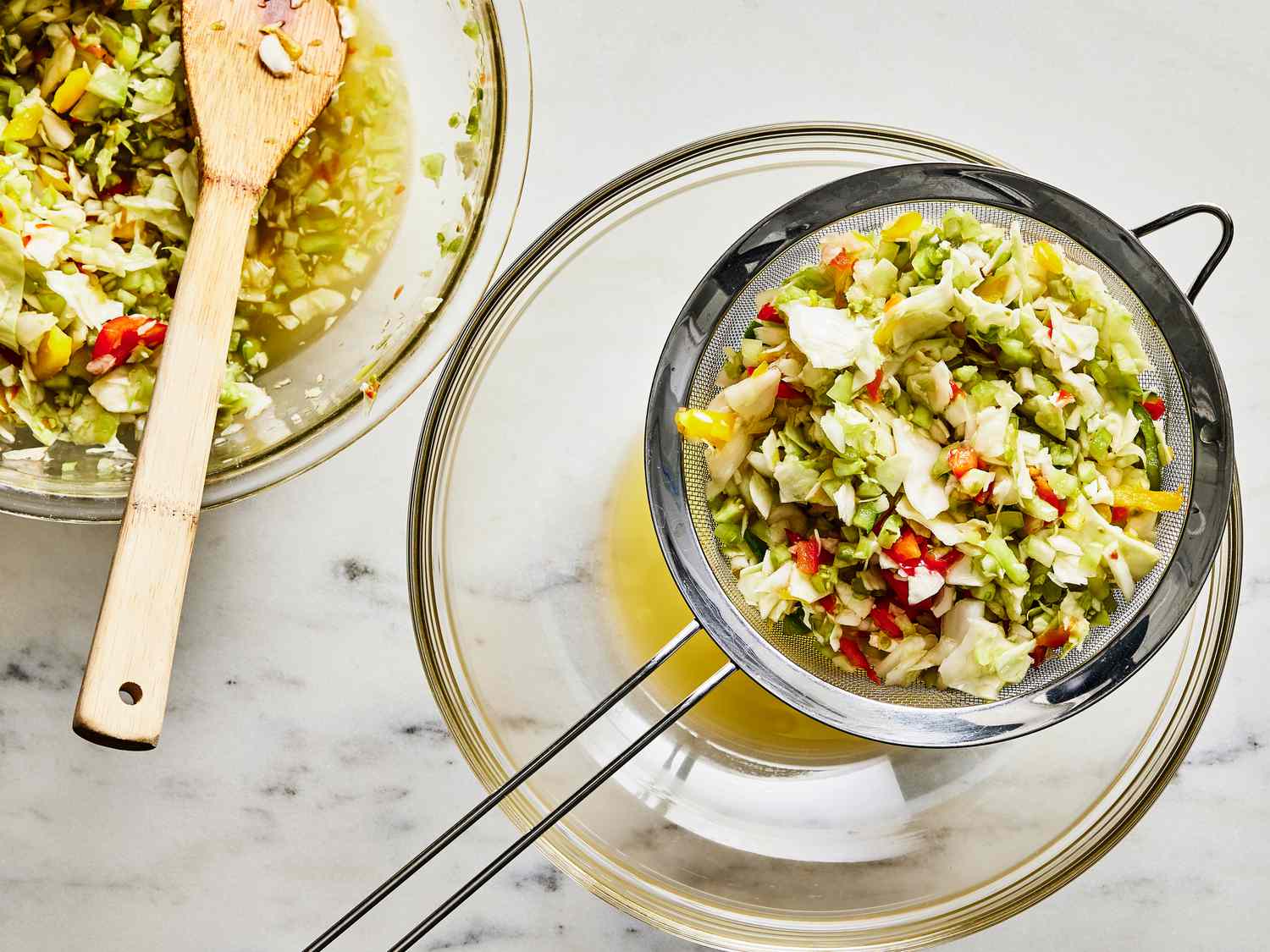 Chow Chow on a mesh strainer, with juice dripping into a bowl underneath it.