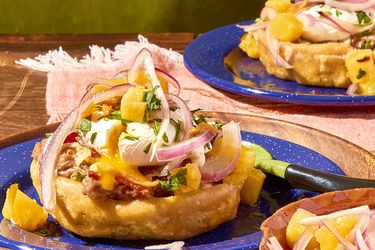 Closeup of breakfast sopes, served on blue plates.