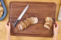 Sliced roasted meat on a Virginia Boys Kitchens Walnut Wood Cutting Board