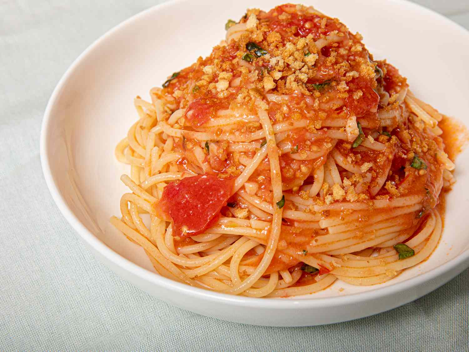 A mound of spaghetti alla carrettiera in a white bowl.