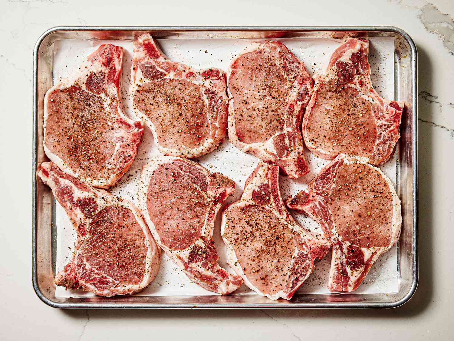 Overhead view of seasoning pork chops