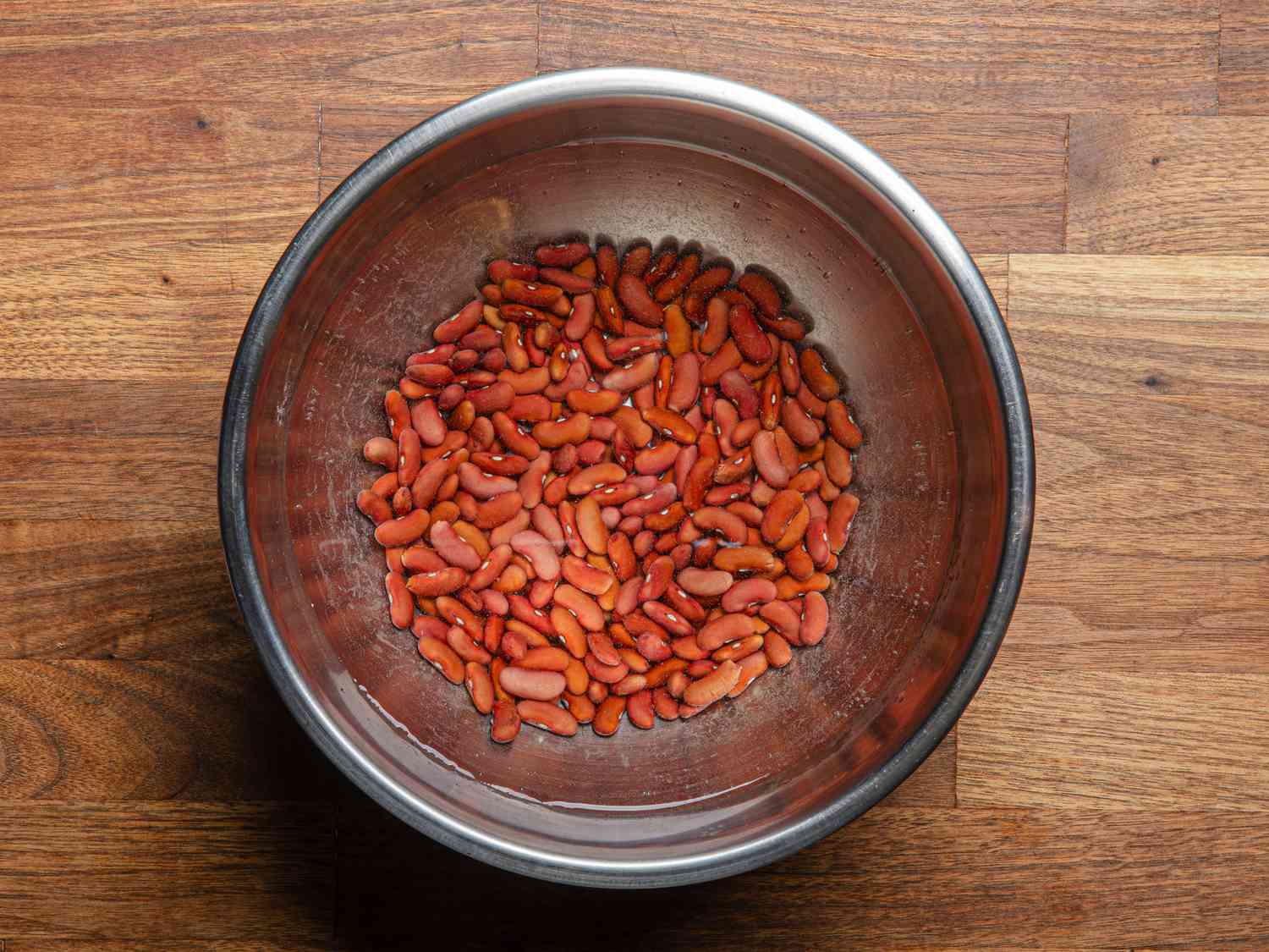 Overhead view of red kidney beans covered in water