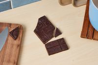 An unwrapped Divine extra-dark chocolate bar.