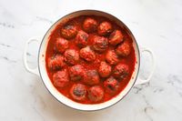 A pot filled with meatballs in tomato sauce