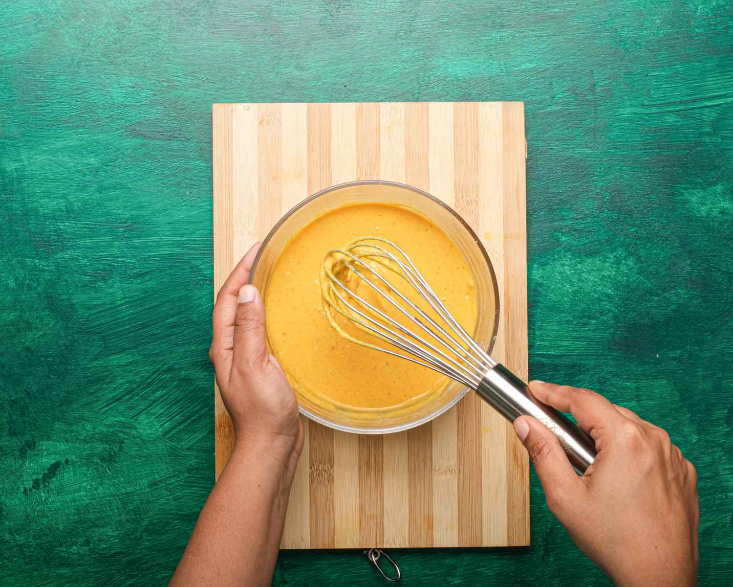 Overhead view of whisking water into bowl