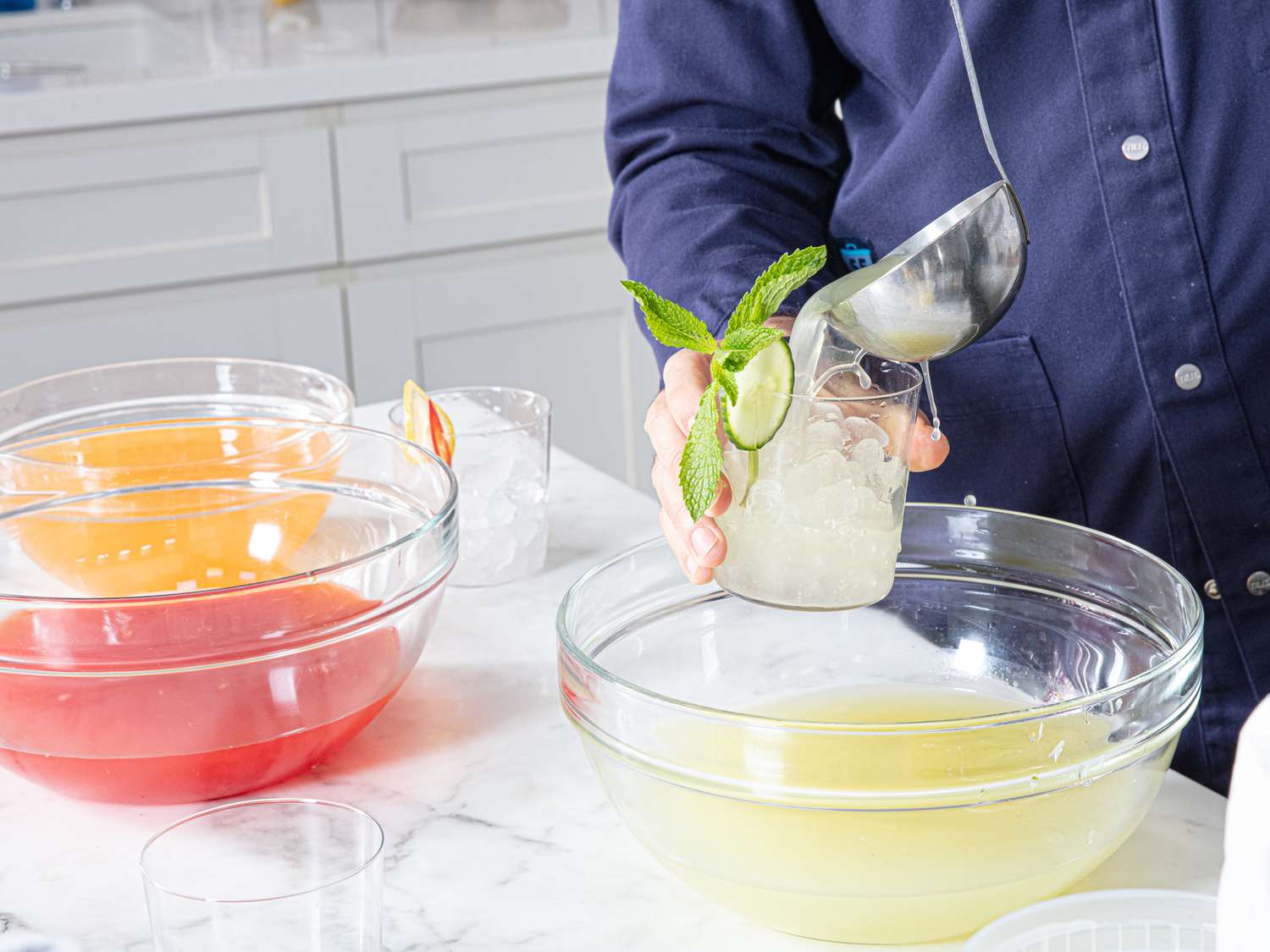 Side view of pouring limeade into a glass