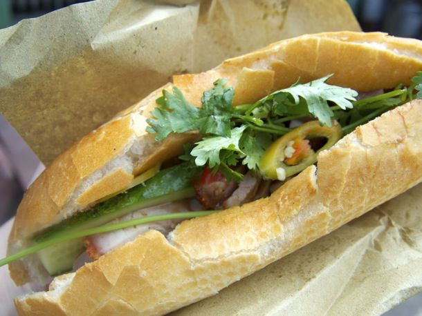 An overhead of a Bánh mì sandwich resting on parchment paper
