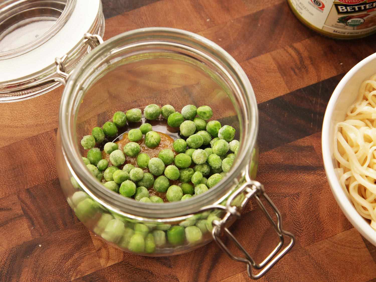 Peas are added to the jar first.