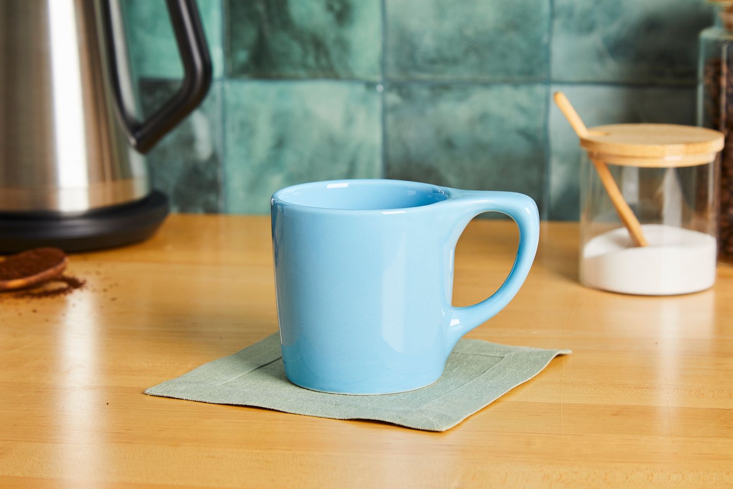 A blue coffee mug on a kitchen countertop.