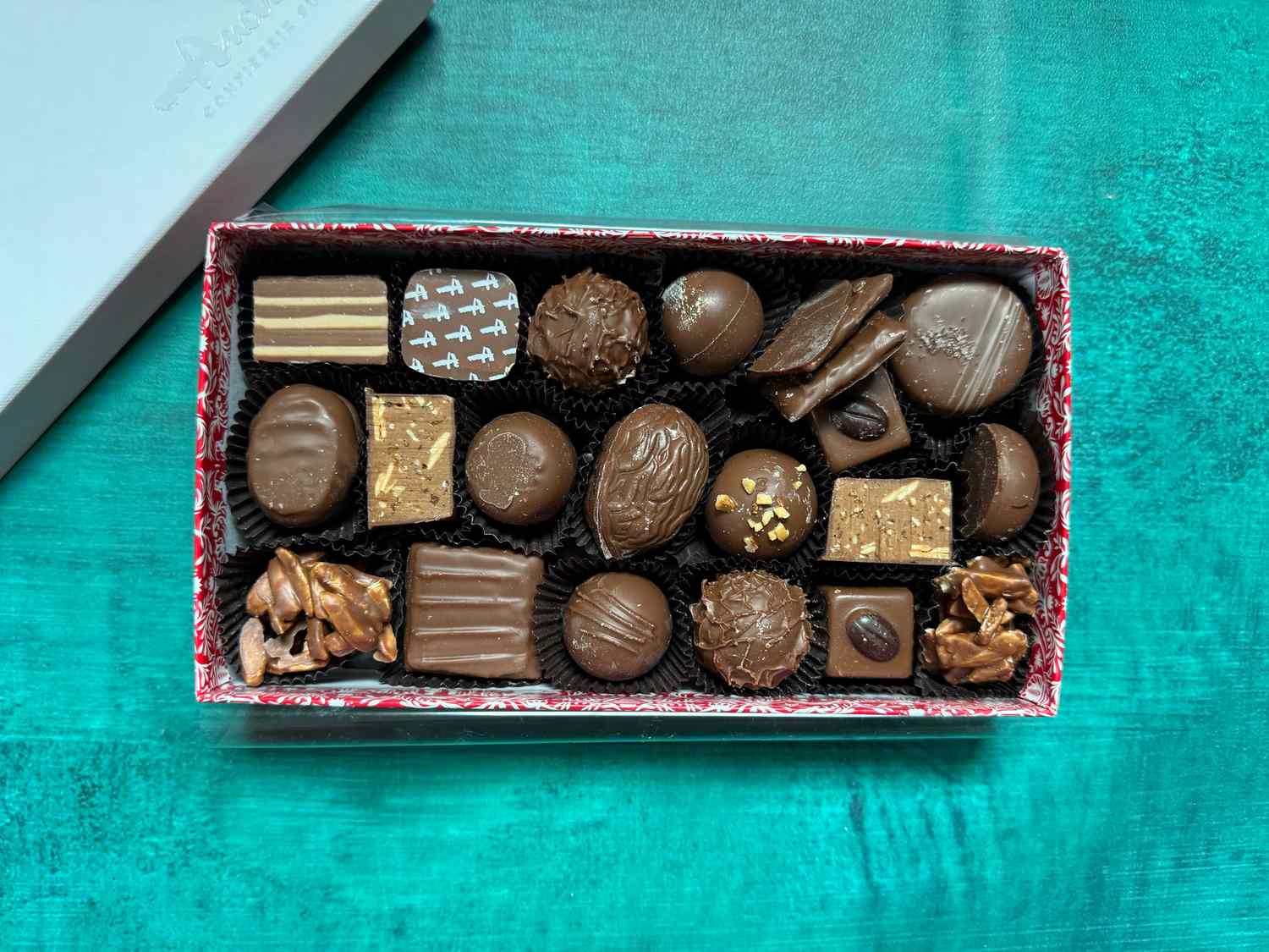 andres chocolates with lid off on a bright blue surface