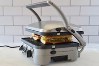 The Cuisinart panini press pressing two Cubano sandwiches.