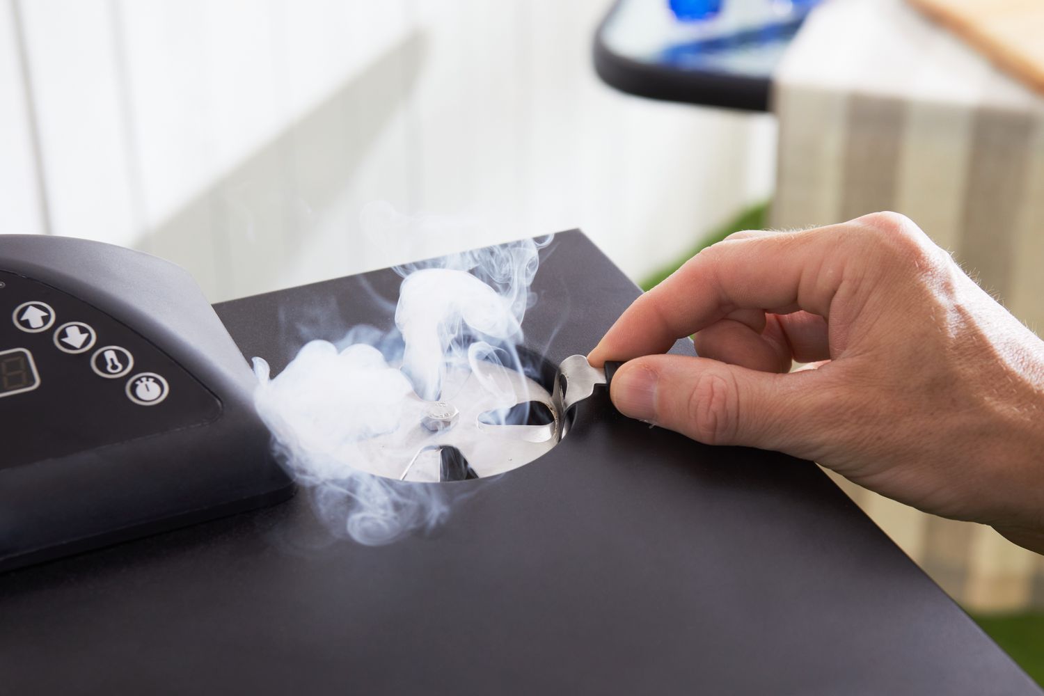 Hand adjusting the smoke release on the Masterbuilt MB20072918 40-Inch Digital Electric Smoker