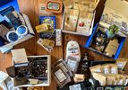 a variety of gift baskets contents on a wooden countertop