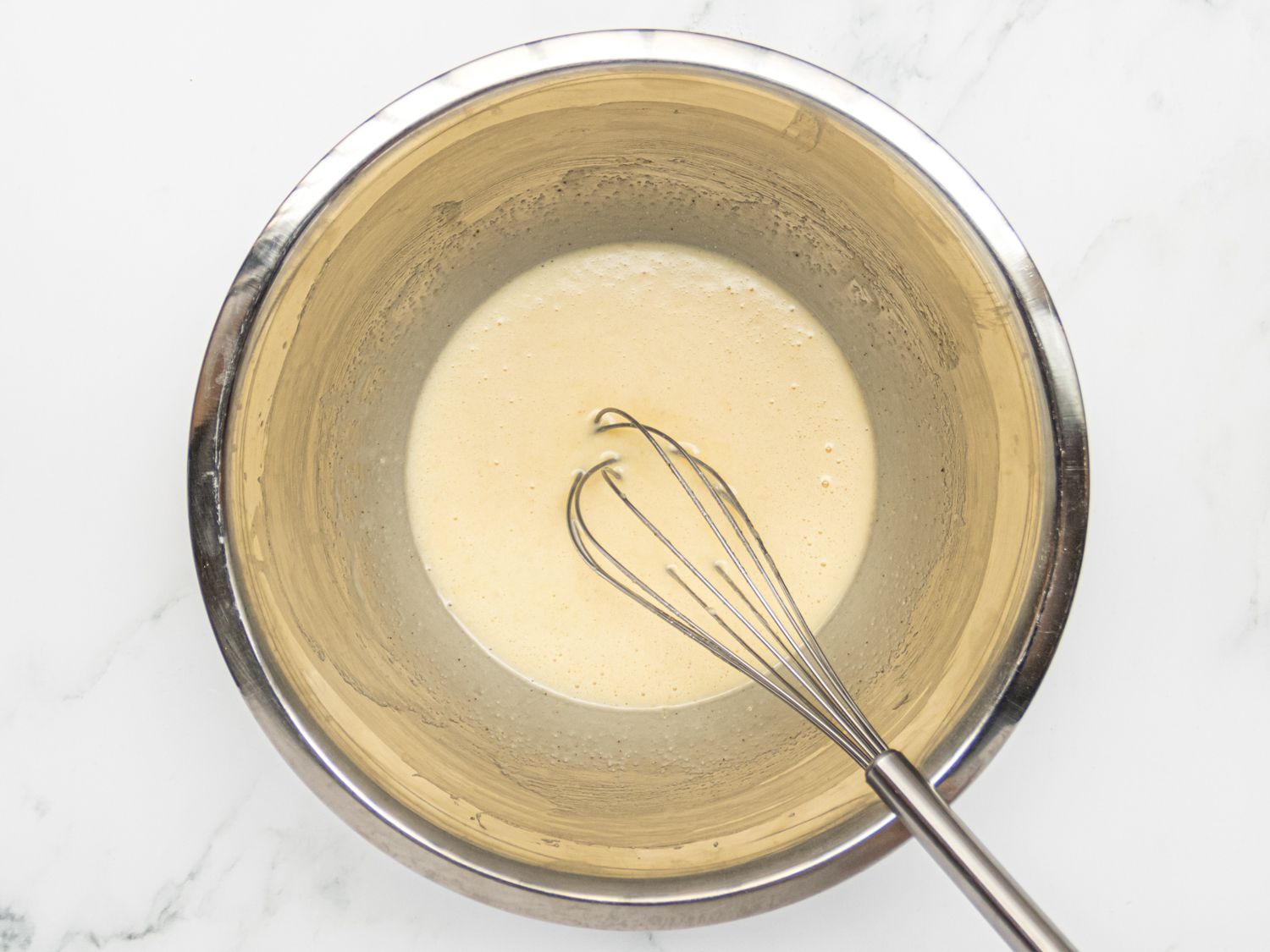 whisking wet ingredients for potato doughnuts