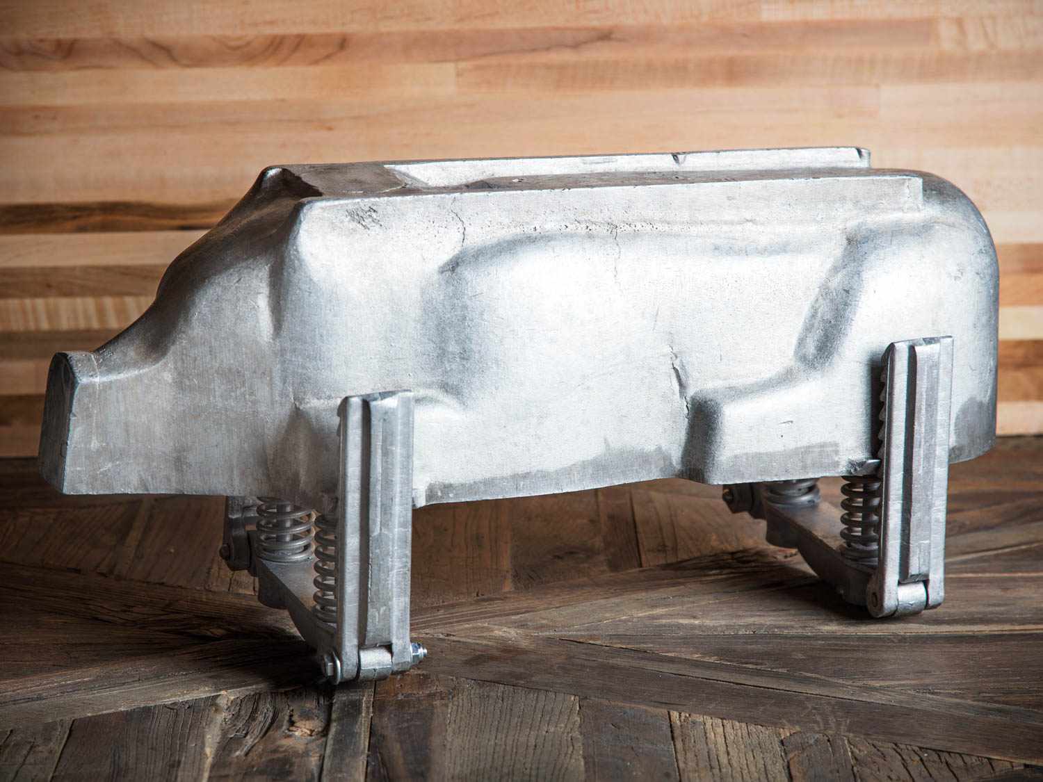 A cast aluminum pig-shaped mold.