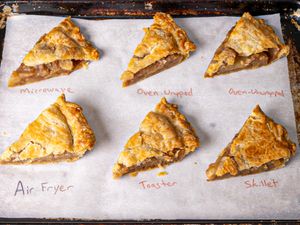 Slices of pie reheated using different methods including microwave oven wrapped oven unwrapped air fryer toaster and skillet