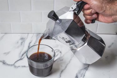 A person pouring coffee from the Bialetti Moka Espress