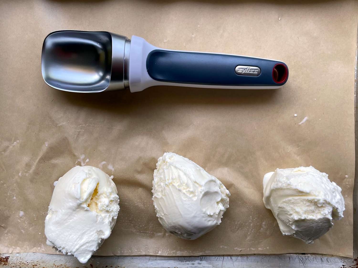 zyliss right scoop with three scoops of vanilla ice cream