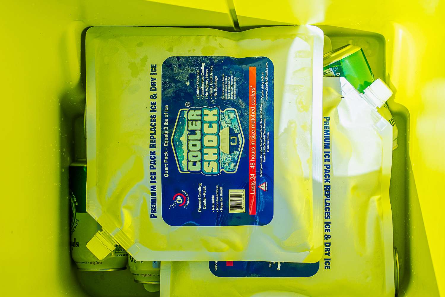 A yellow cooler filled with ice packs and beverages