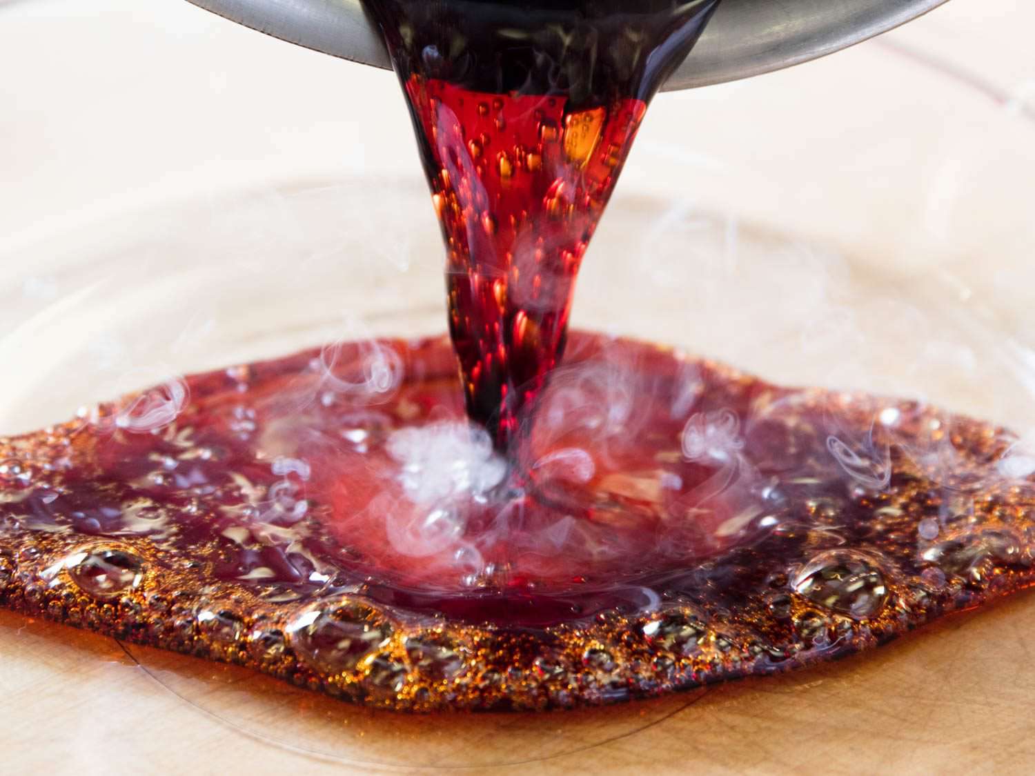 Pouring caramel into a baking dish for double-caramel flan.