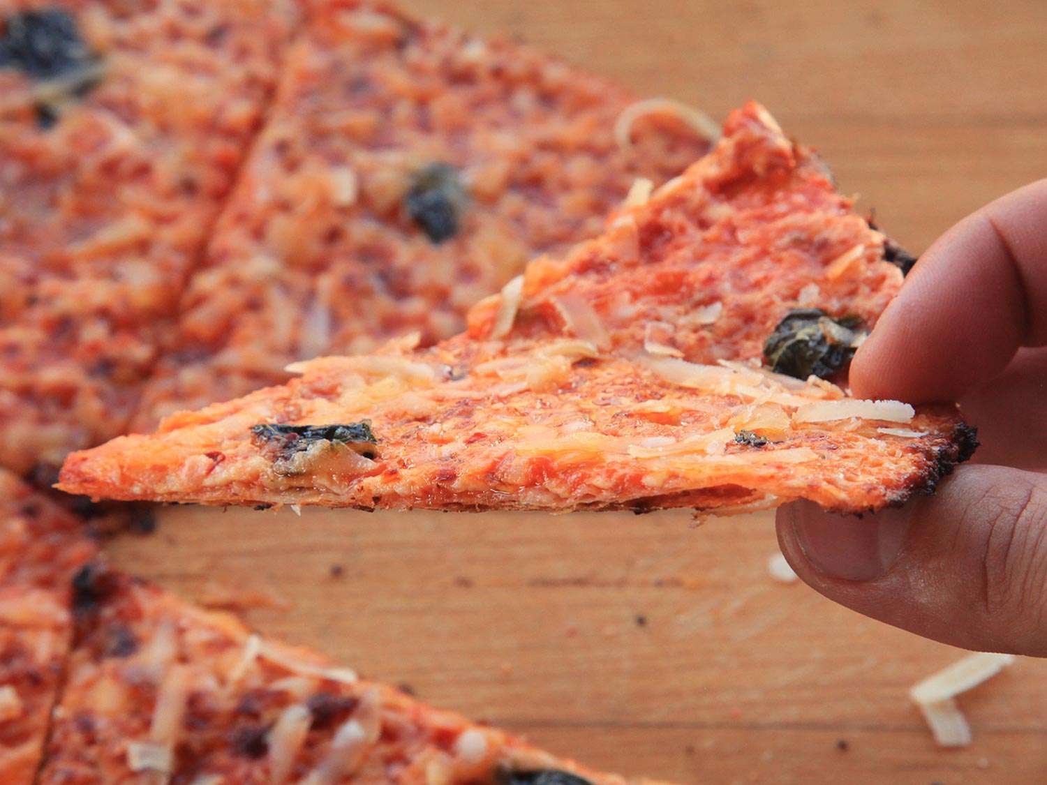 Author holding a slice up above the cutting board.