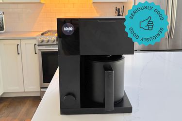 The Fellow Aiden coffee maker on a kitchen countertop.