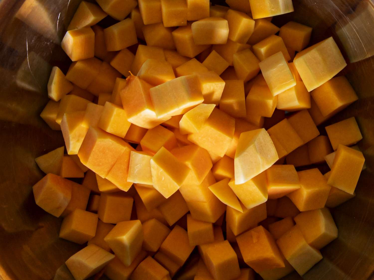 Chopped butternut squash in a metal bowl