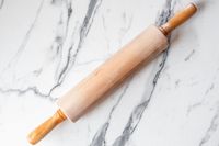 A J.K. Adams Maple Wood Medium Gourmet Rolling Pin on a marble surface
