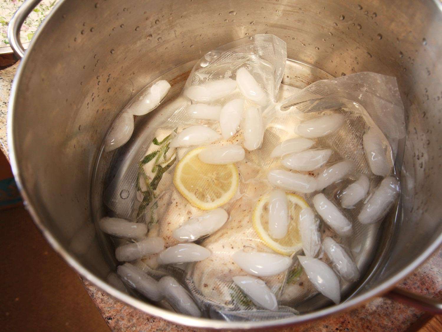 Bagged sous vide chicken breast chilling in ice water.