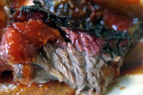 Burnt ends from brisket with sauce on top. 