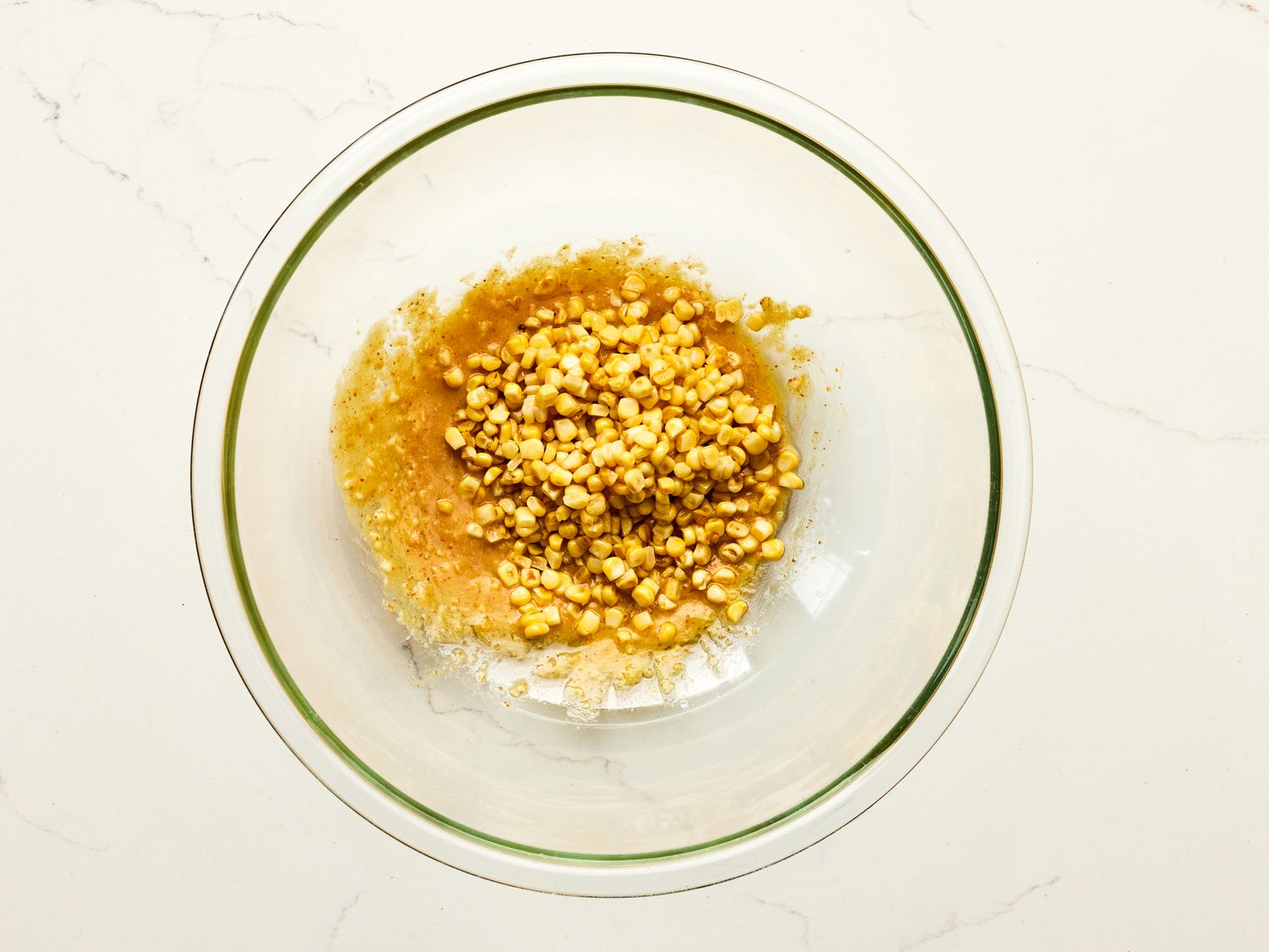 Overhead view of corn being adding to dressing