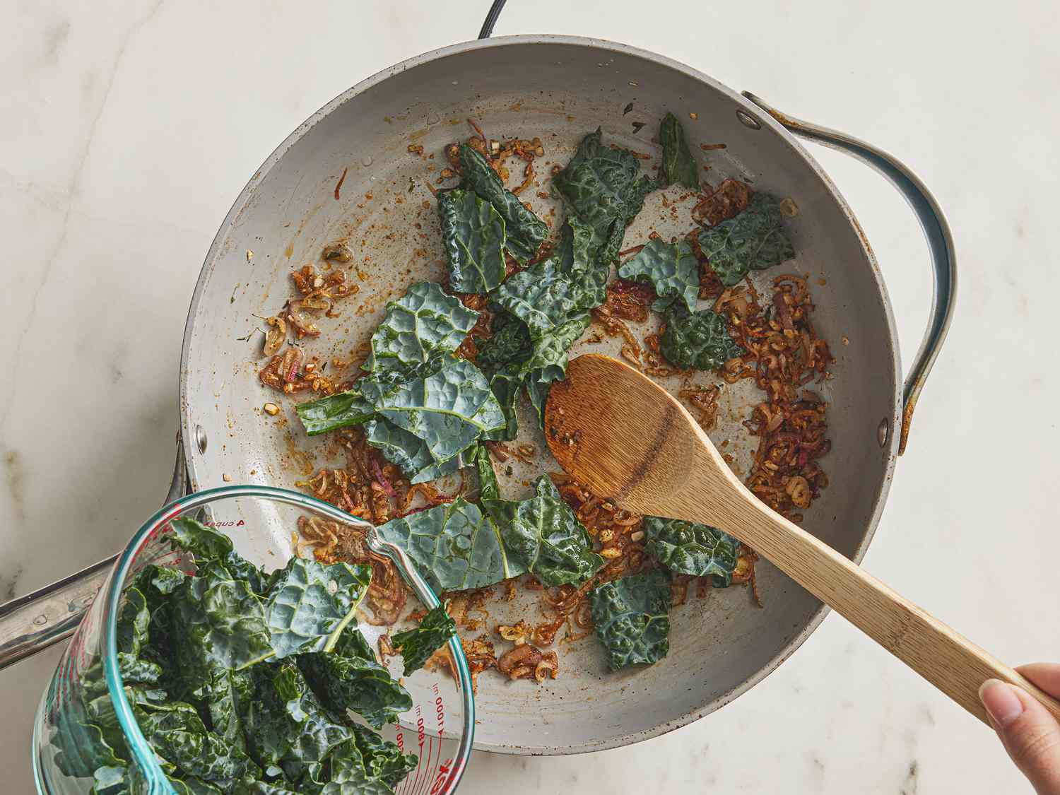 kale sauteing in a skillet