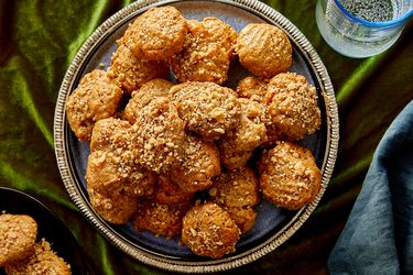 A plate of cookies topped with crumbled nuts