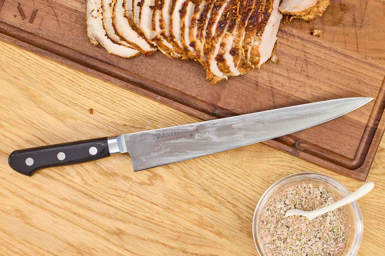 The Misono Molybdenum Steel Sujihiki Knife rests on a cutting board