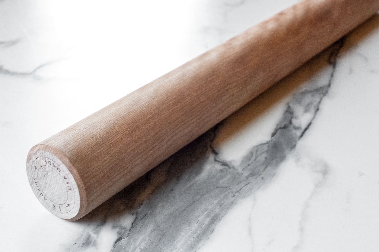 A J.K. Adams Dowel Rolling Pin on a marble countertop