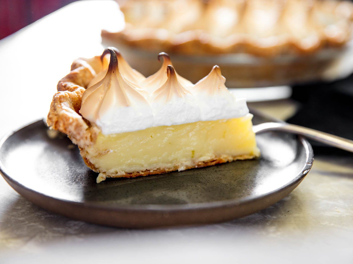 Slice of lime pie with meringue on a plate