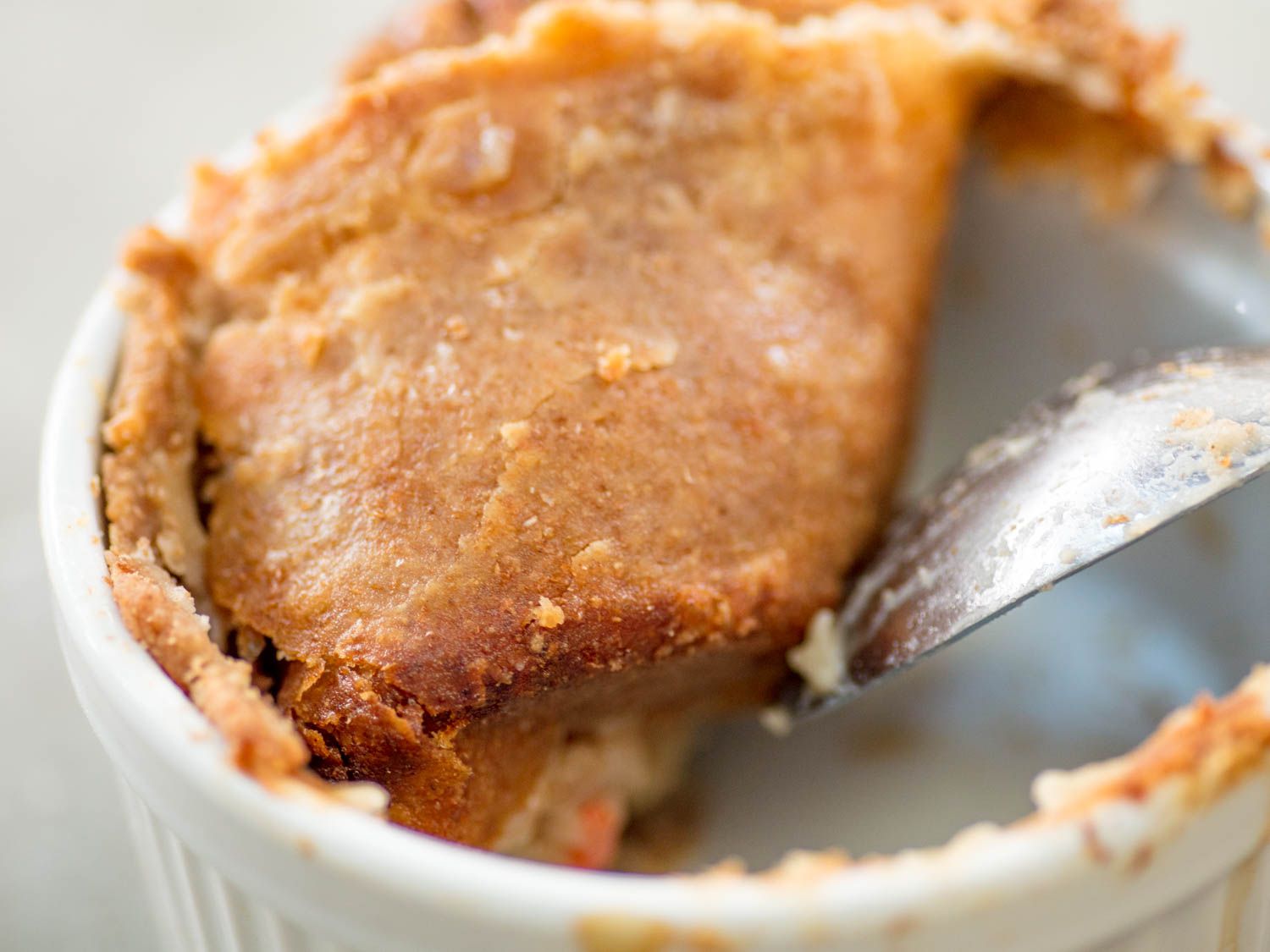 A double-crusted chicken pot pie made with whole wheat pie crust. The top crust is a dark golden brown.