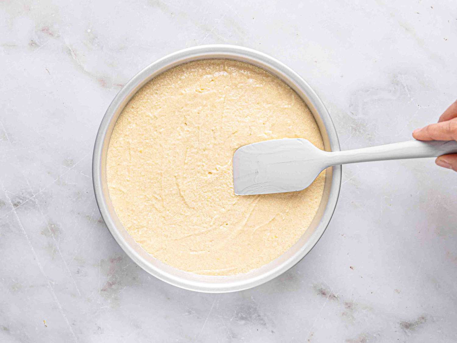 Overhead view of smoothing cake batter 