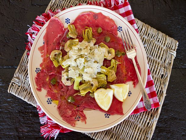 Carpaccio topped with sliced fennel and artichokes.