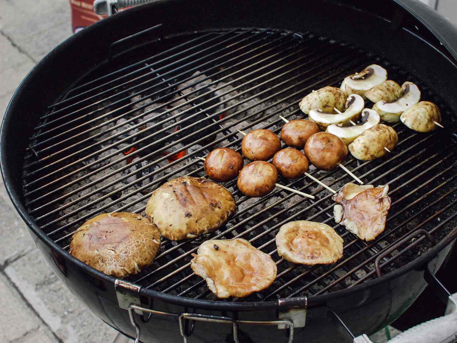 A variety of mushrooms on the grill. 
