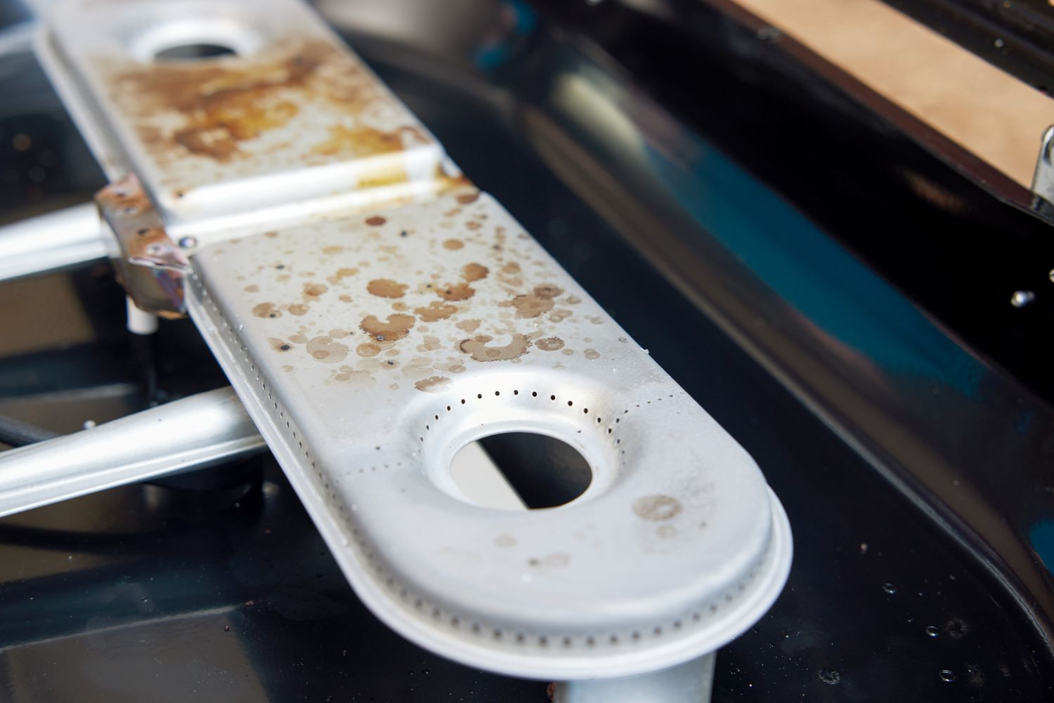 A closeup shot of the burners on a gas grill.