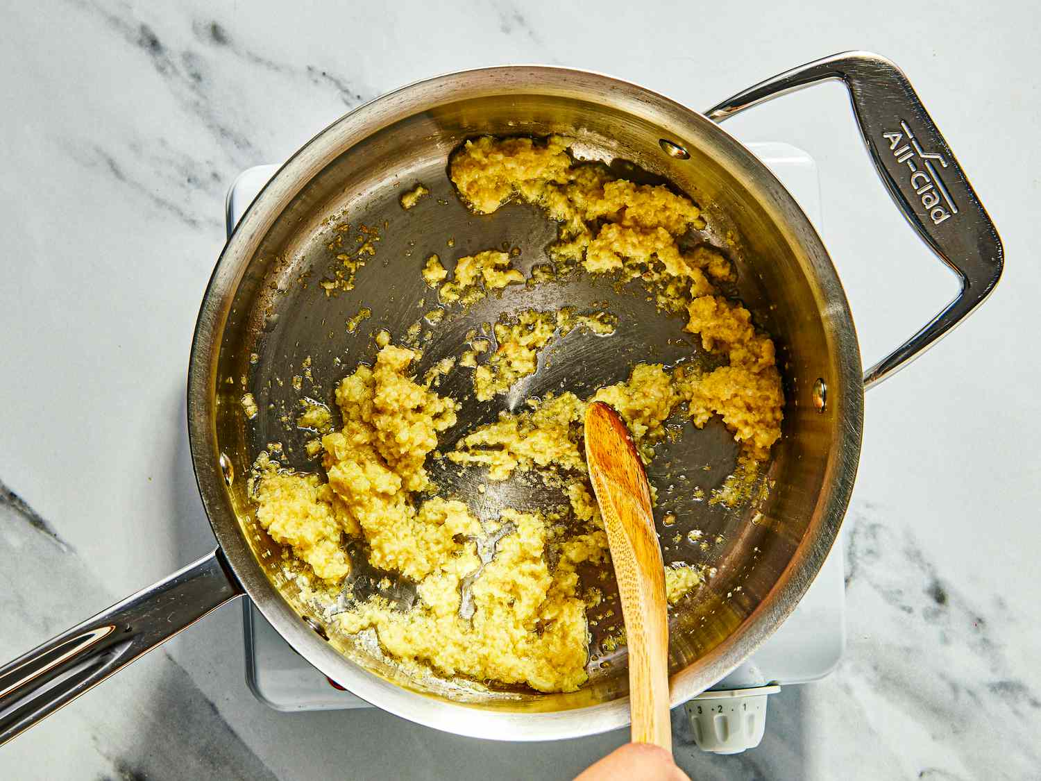cooking gingler and garlic in saucepan
