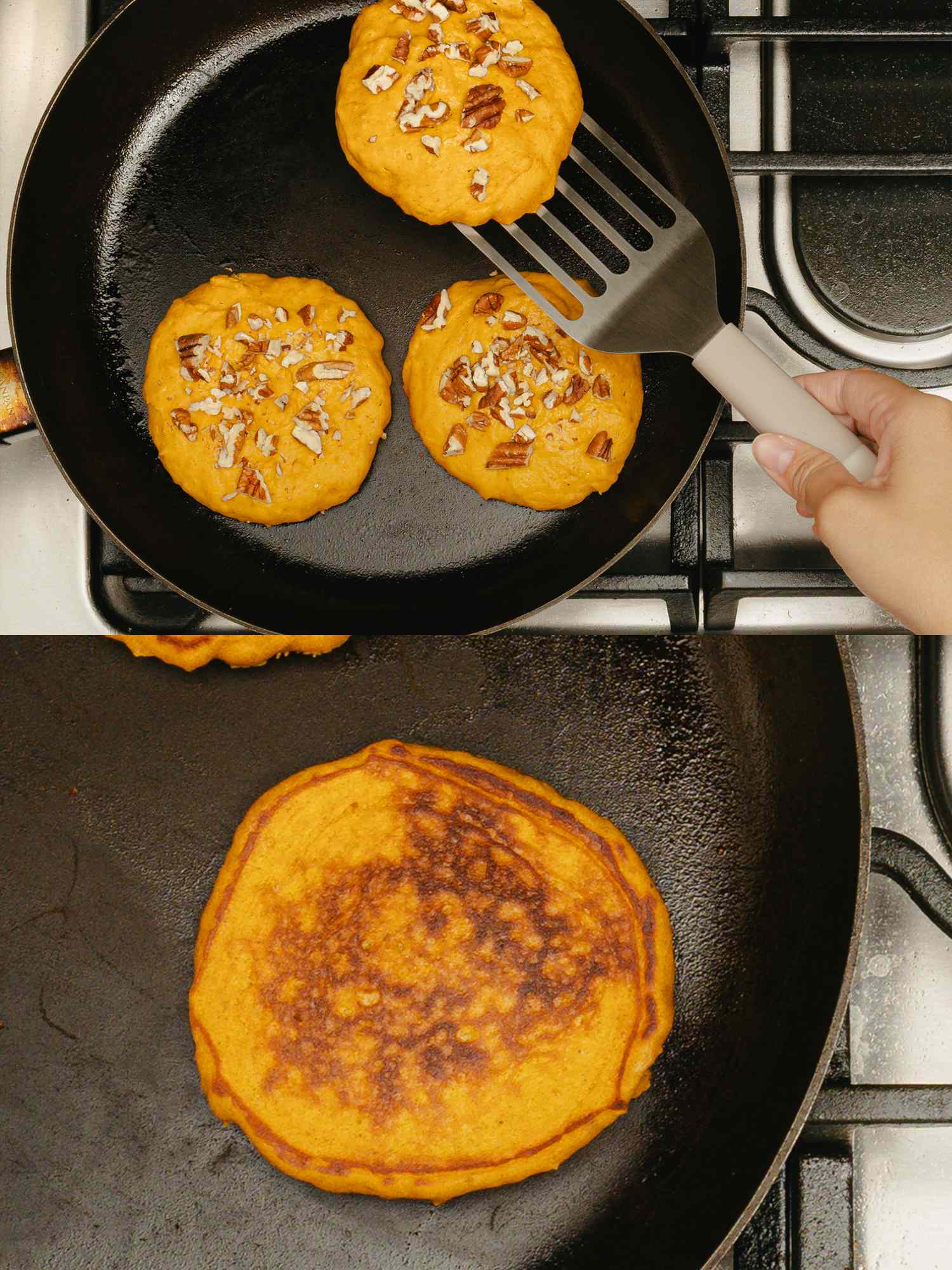 Pumpkin pancakes cooking in a skillet one with pecans being flipped with a spatula